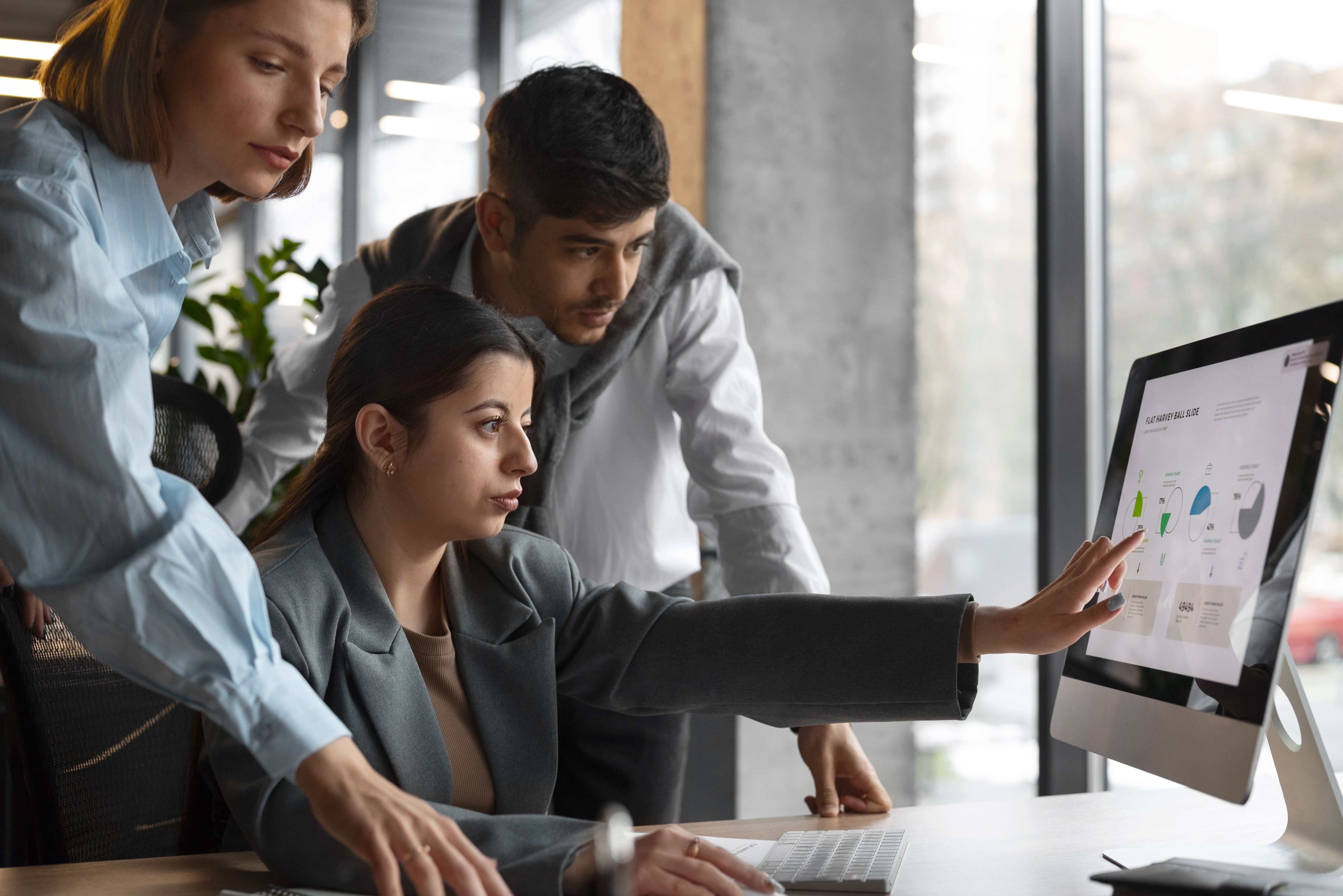 Business professionals planning an IT strategy on a whiteboard.
